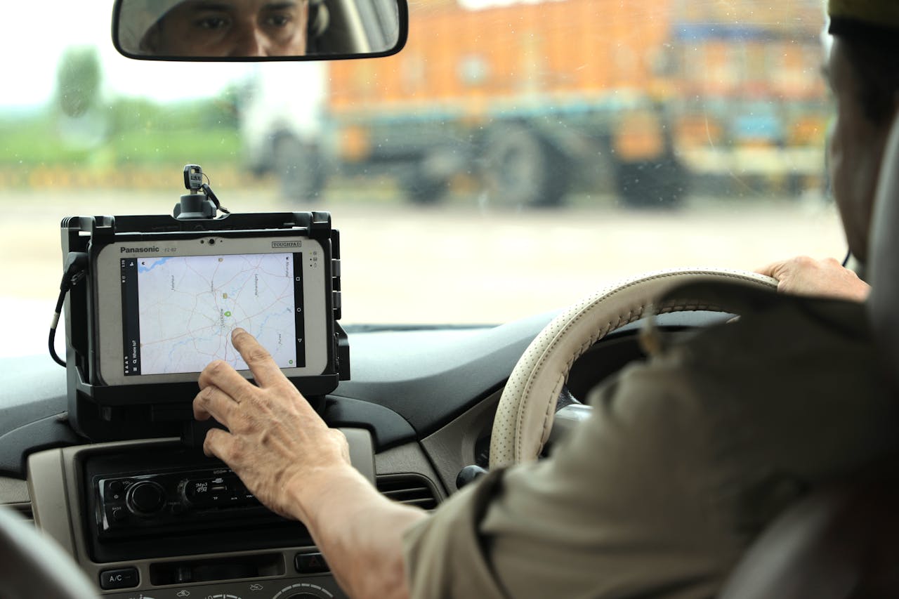 heros-img Police officer navigates using a digital map on a tablet inside a vehicle.