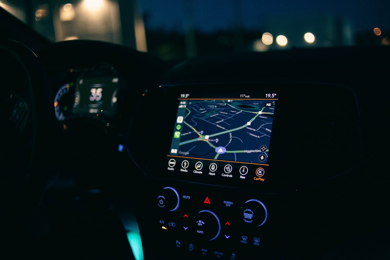 about-us Interior view of a car featuring the GPS navigation system illuminated at night, showcasing technology and modern travel.